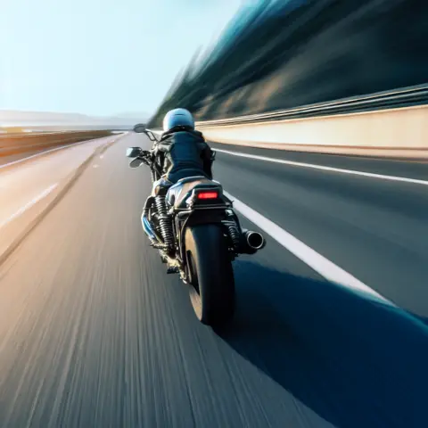 Motorcycle traveling at speed down road